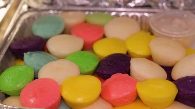 Enjoy puto from the Philippines made from rice flour and served with grated coconut in a local kitchen