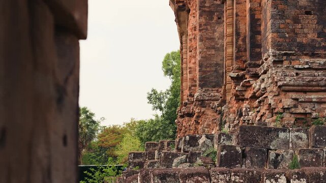 Closeup view of My Son Sanctuary in Quang Nam Vietnam showing weathered brick temple walls, stone steps, historic Cham architecture, and surrounding greenery