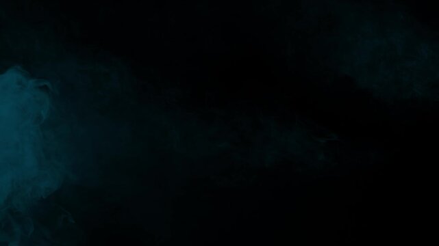 Wisps of arctic blue smoke entering from the left side of a dark screen. Isolated on black background, perfect for vfx compositing, atmospheric overlays, and creating a cool mood