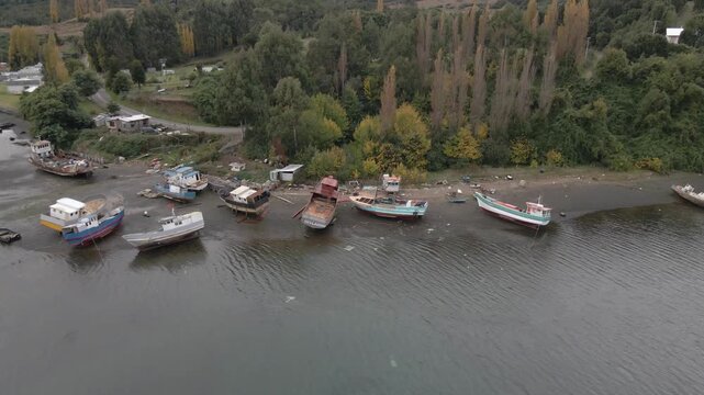 Fishing boats resting on the shore close to the City of Ancud in Souther Chile.