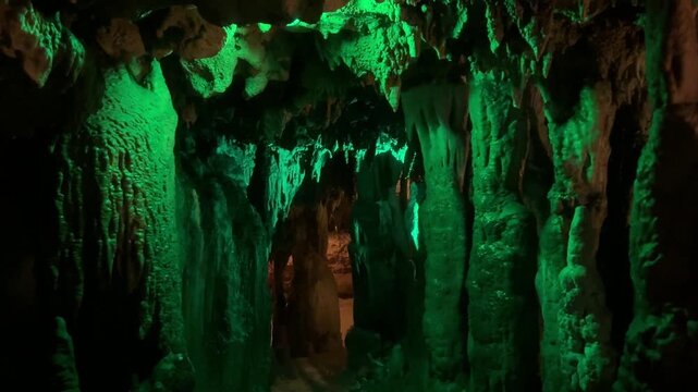 Terrifying view of enormous stalagmites in illuminated cave. Florida Caverns State Park. Zoom in