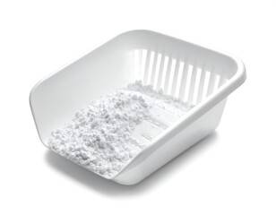 White powdered substance partially fills a plastic scoop with a slotted section, all against a bright white backdrop