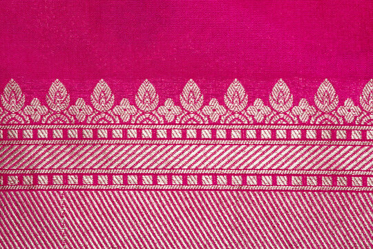 Pink Indian saree displaying traditional zari border pattern