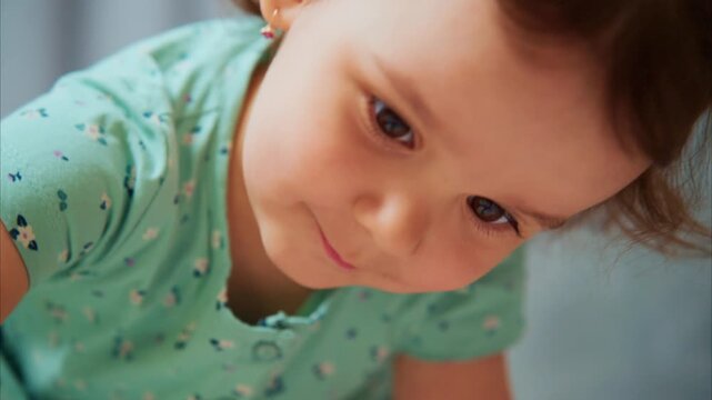 A Charming Young Child Captivates with a Sweet Expression and Curious Glance, Showcasing Innocence and Wonder in a Playful Environment