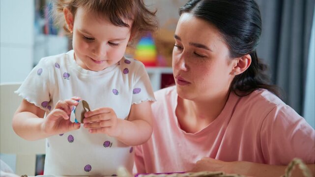 An Engaging Moment Between a Young Child and an Adult as They Create Colorful Crafts Together, Celebrating Creativity and Bonding in a Warm, Inviting Atmosphere