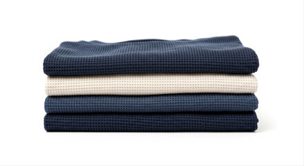 Stack of waffle knit shirts in navy and white, neatly folded and isolated on a pristine white background
