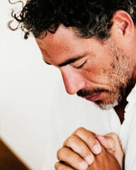 Obraz premium Man in Prayer Seeking Divine Comfort and Mental Health Support, Deeply Emotional Worship in a Bright Indoor Setting for Spiritual Faith and Religious Social Media Content