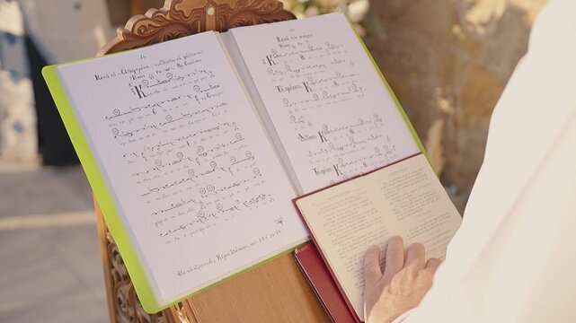 Priest reading Orthodox wedding script, outdoors, sunny day