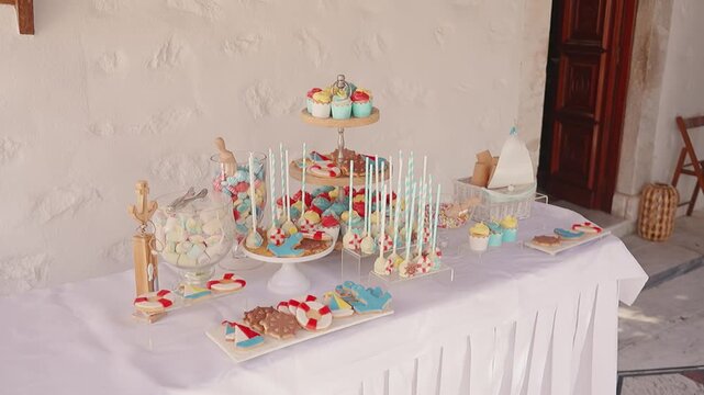 Candy buffet for a baptism outdoors, festive and colorful treats ready