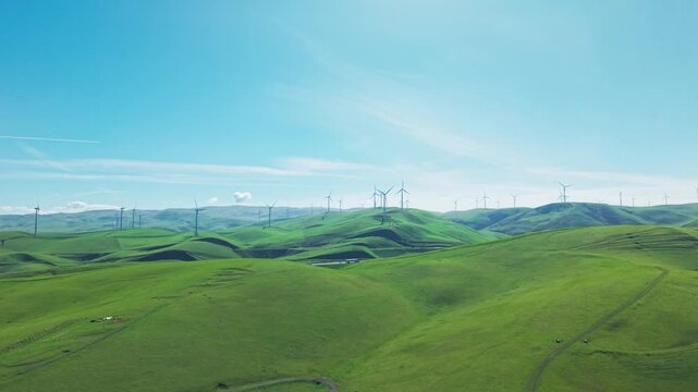 Drone perspectives reveal the expansive turbine fields near Altamont Pass in Dublin, where technology and nature intersect across sunlit slopes.