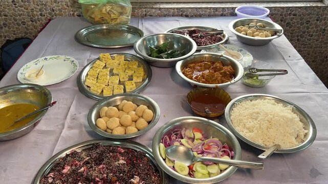 Bengali catering food, which includes rice, saag, chicken, sandesh, and pan
