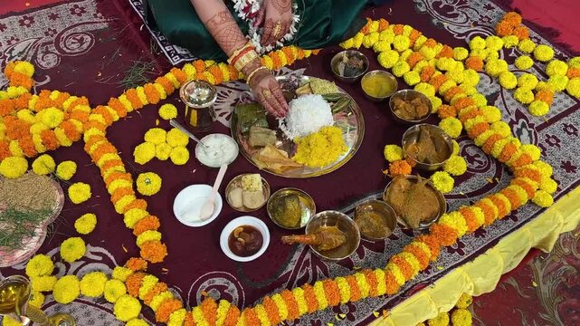 A Bengali bride eating Aiburobhat thali for her wedding