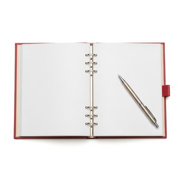 Open red ring binder with blank pages and a silver pen on a white background
