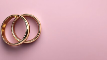 Elegant Wedding or Engagement banner background - pair of golden wedding rings and gentle white bow ribbon on gentle pink backdrop, copy space for text