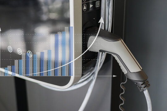 Electric vehicle charging station with graph overlay showing growth trends, symbolizing rise in electric vehicle adoption and sustainable energy solutions