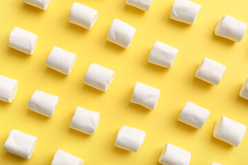 Sweet marshmallows on yellow background