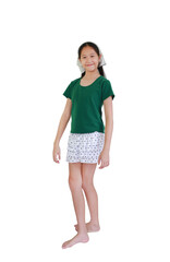 Fototapeta premium Charming young Asian girl smiling happily while wearing green t-shirt, a polka dot tiered skirt, standing against white background.