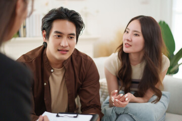 Asian couple talking with psychologist during relationship counseling session