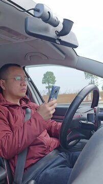 A male driver&rsquo;s using his phone while driving,  that&rsquo;s reckless driving.