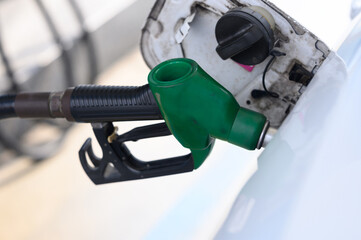 refuel the car. a woman at a gas station on a sunny summer day refuels the car with fuel.