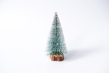 Miniature winter pine tree with snow. Festive christmas and holiday atmosphere, isolated on white background