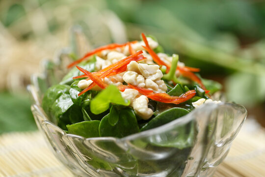 Cold dish of peach kernels and andrographis paniculata served in a dish