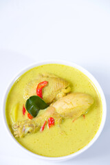 Opor ayam or Indonesian chicken stew in coconut milk is a festive delight, commonly served during Eid-al Fitr or lebaran. Isolated on white background