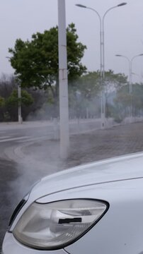 The car engine overheats and steams. The damaged engine keeps blowing white smoke.
