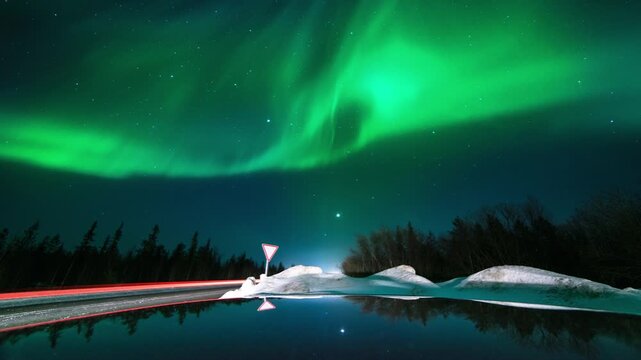 This animation of the northern lights was created in Adobe After Effects. Northern lights and the starry sky reflecting on the water.
Beautiful green and red aurora dancing over the hills.