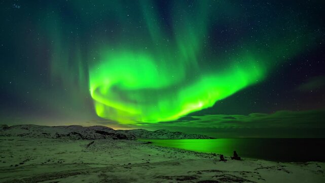 This animation of the northern lights was created in Adobe After Effects. Northern lights and the starry sky reflecting on the water.
Beautiful green and red aurora dancing over the hills.