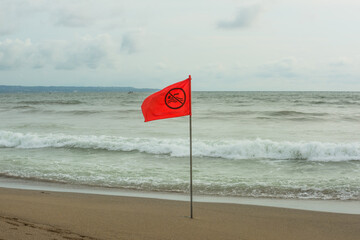 Red Warning Flag on Tropical Beach Against Rolling Ocean Waves &ndash; Coastal Caution Beauty