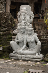 Elegant Balinese Stone Sculptures of Deities in Shaded Temple Garden &ndash; Tropical Artistic Serenity