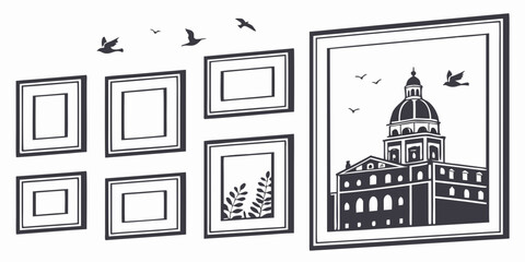 A collection of framed pictures on a wall with a large painting of a building. © Tff