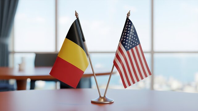 Belgian and American flags on a table in a modern office setting