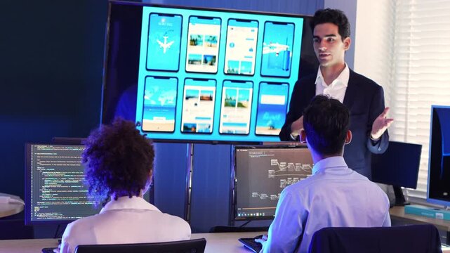 Professional team of developers and UI UX designers collaborating on mobile app interface layouts, analyzing code and software architecture on multiple screens at the office meeting