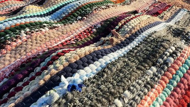 Close up of Egyptian striped rug painted thread pattern