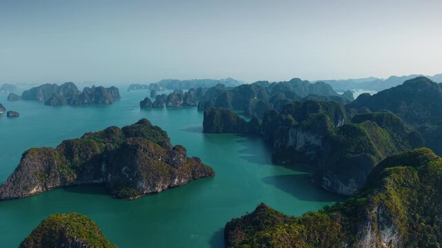 Breathtaking sunrise over Halong bay's limestone karsts and serene waters.