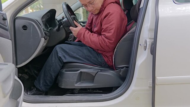 The driver adjusts the seat forward and backward.