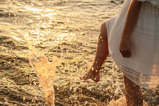 woman touchers the water her foot