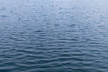 Obraz premium lake ripple background and texture. Abstract background with blue waves and natural ripples on the water. The rich dark blue color of river, lake or sea water. The water surface.