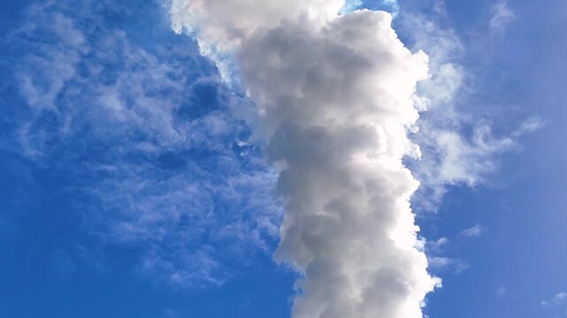 Close Up of Thick White Smoke Billowing Into Blue Sky