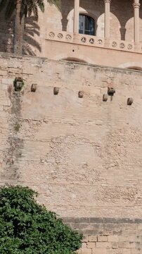 Royal Palace of Almudaina facade wall in Palma de Mallorca, Spain. Tilt shot.