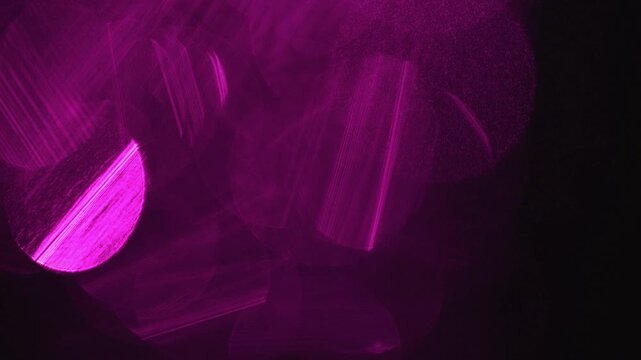 Light leak and bokeh overlay with vibrant magenta circles and streaks, creating a luminous and dreamy effect. This footage is ideal for adding visual flair to videos.