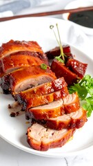Sliced glazed roast pork on a white plate with sauce and garnish