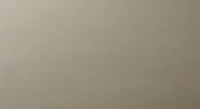 A close-up view of a light taupe textured surface showing a subtle gradient from top to bottom