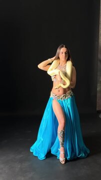 Mesmerizing Belly Dancer with Snake in Studio Footage