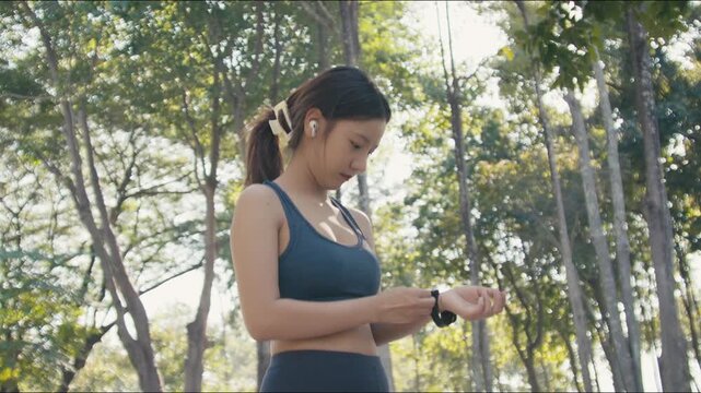Asian woman prepares for outdoor exercise in park