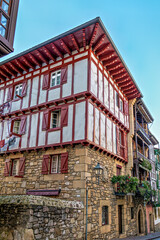 Naklejka premium Colorful Buildings, Red Shutters, Flower Balconies, Cobblestone Street, Traditional Architecture in Hondarribia, Spain