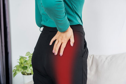 Woman suffering from sciatica or hip pain with red highlight on leg. Concept of nerve pain, muscle injury, joint inflammation