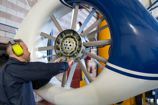helicopter mechanic performing an inspection